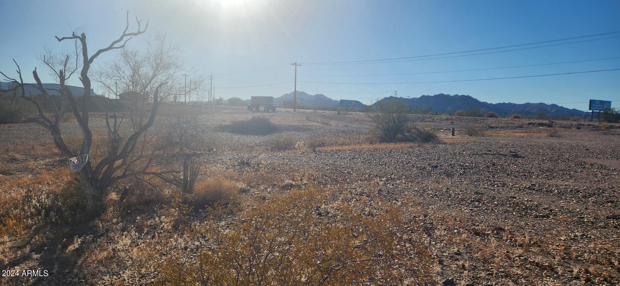 1925 Dome Rock Road West Quartzsite, AZ 85346 - Photo 11 of 12 a view of a dry yard with wooden fence