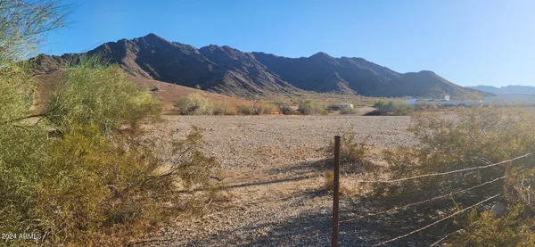 a view of a house with a mountain and a forest