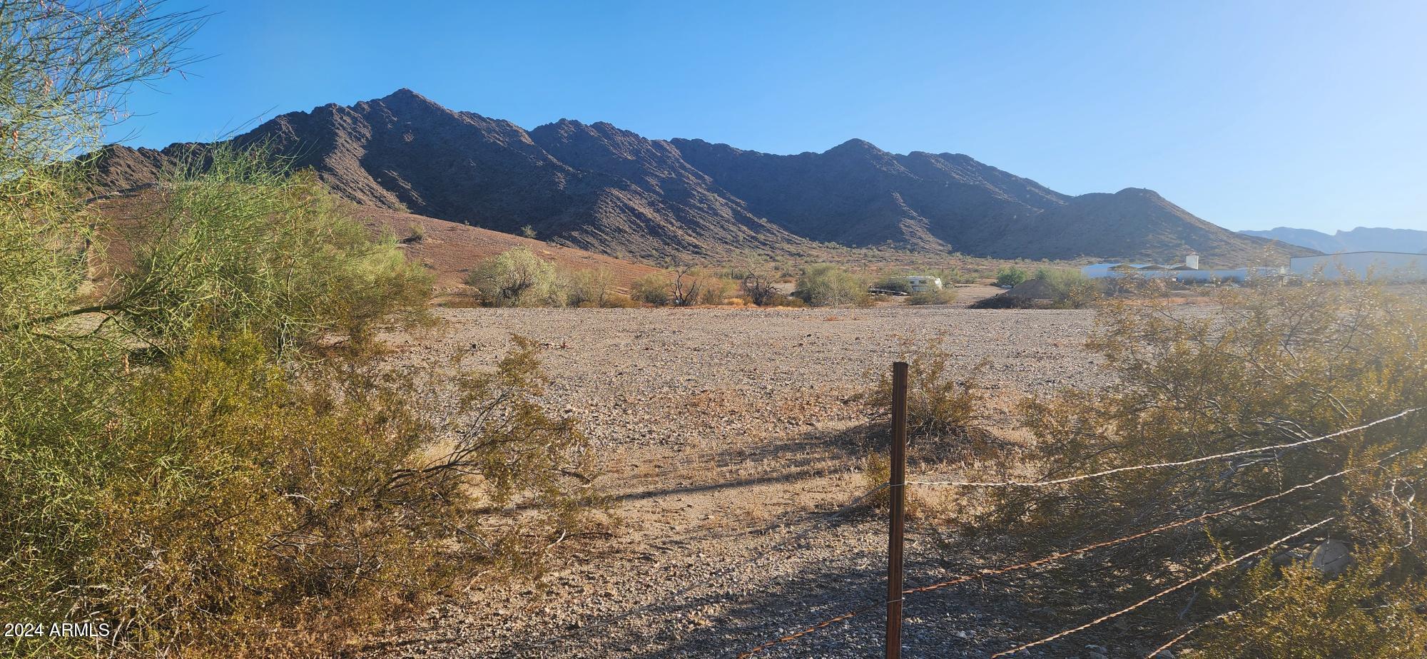 1925 Dome Rock Road West Quartzsite, AZ 85346 - Photo 4 of 12 a view of a house with a mountain and a forest