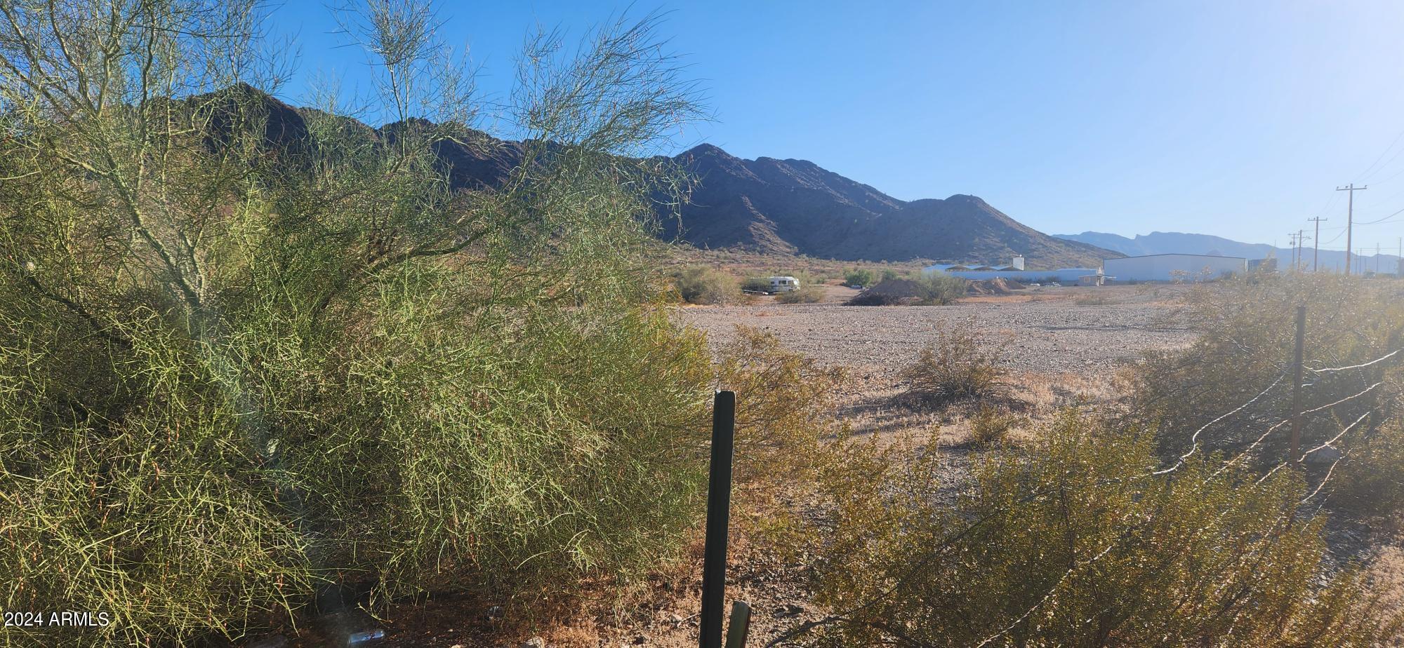 1925 Dome Rock Road West Quartzsite, AZ 85346 - Photo 5 of 12 a view of a house with a mountain and a forest