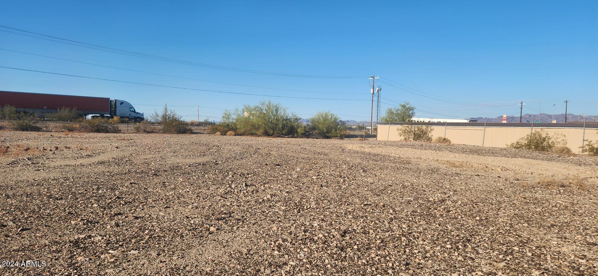 1925 Dome Rock Road West Quartzsite, AZ 85346 - Photo 7 of 12 a view of a dry yard with wooden fence