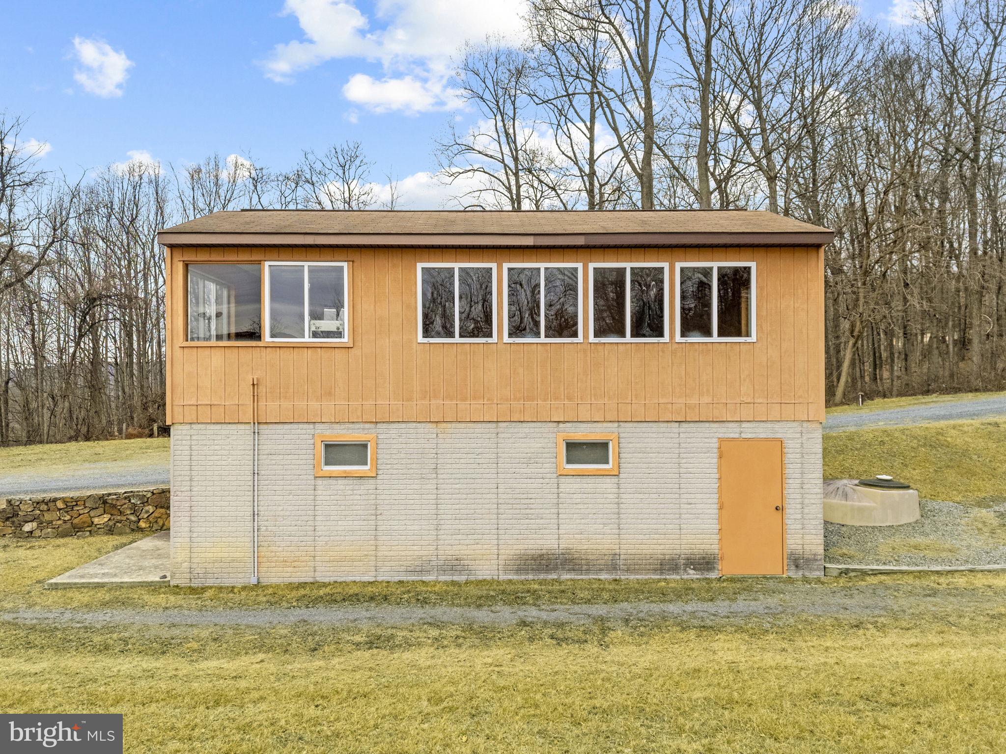 303 Barbeque Drive Berkeley Springs, WV 25411 - Photo 34 of 68 a front view of a house with a large tree