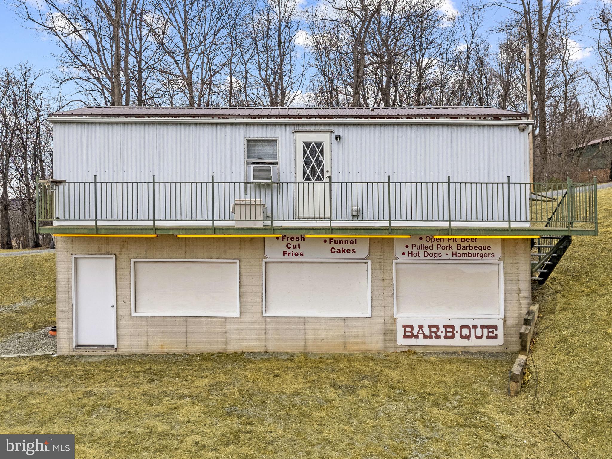 303 Barbeque Drive Berkeley Springs, WV 25411 - Photo 50 of 68 a view of a house with pool and a yard