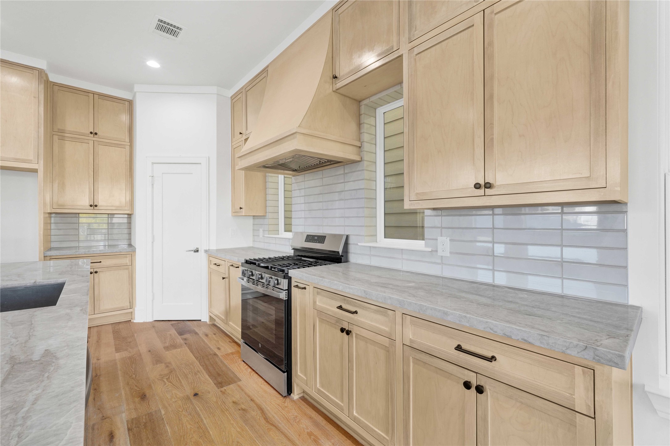 5439 Darling Street Houston, TX 77007 - Photo 14 of 42 The kitchen features custom-built cabinets, Taj Mahal countertops, ample storage, and a walk-in pantry.