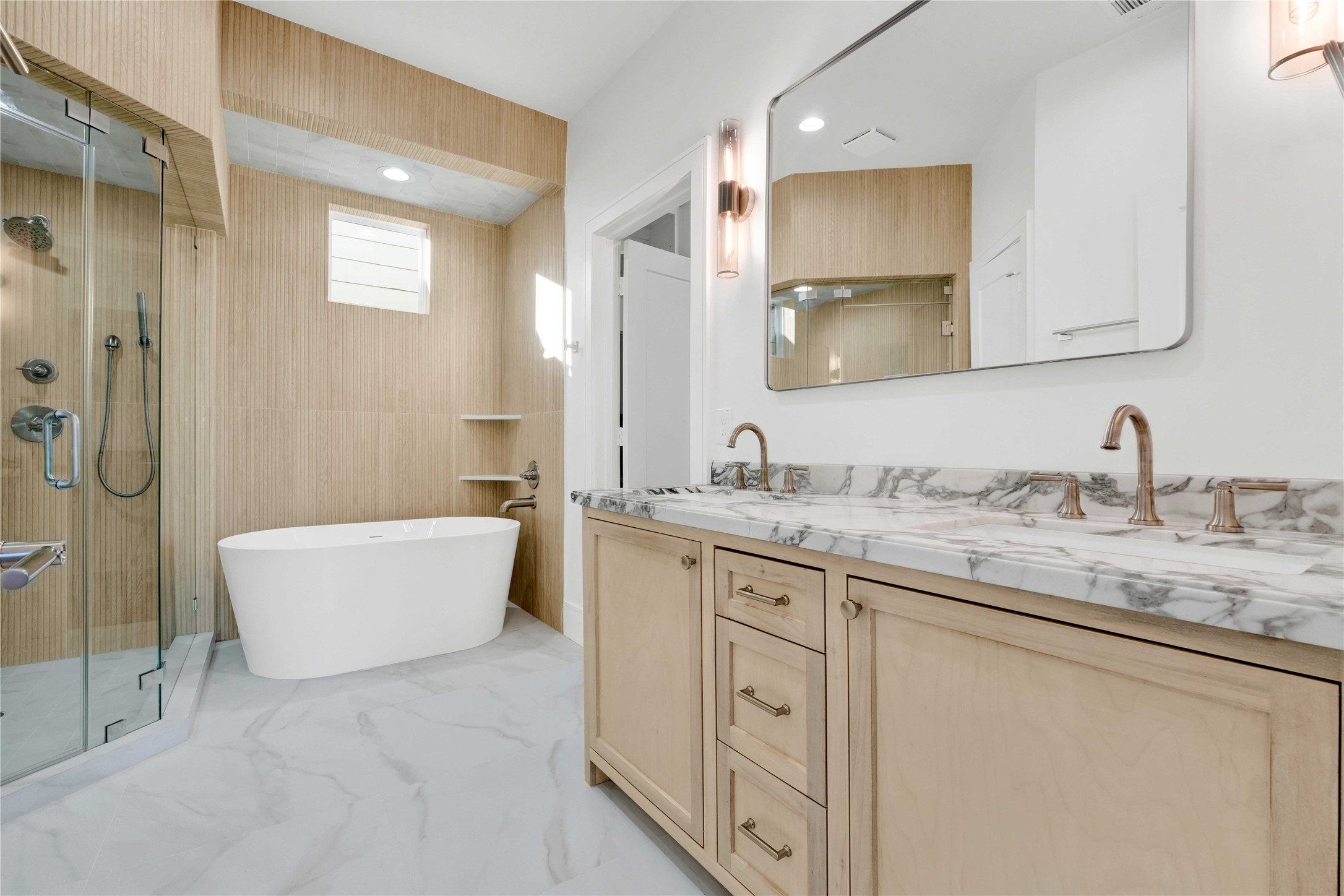 5439 Darling Street Houston, TX 77007 - Photo 24 of 42 A beautifully designed primary bathroom with custom-built vanities, premium tilework, and a modern freestanding soaking tub.