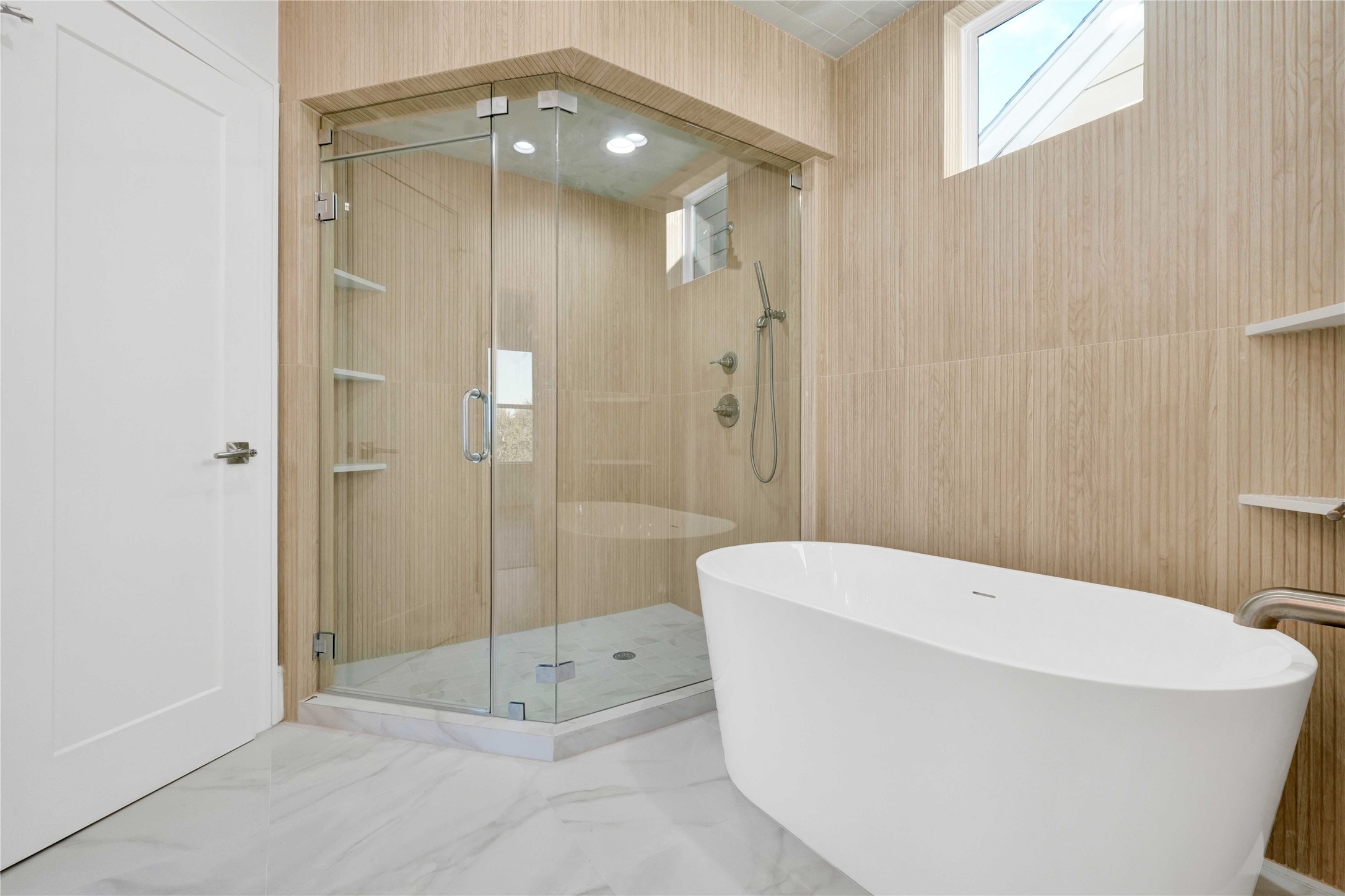 5439 Darling Street Houston, TX 77007 - Photo 25 of 42 A beautifully designed primary bathroom with custom-built vanities, premium tilework, and a modern freestanding soaking tub.