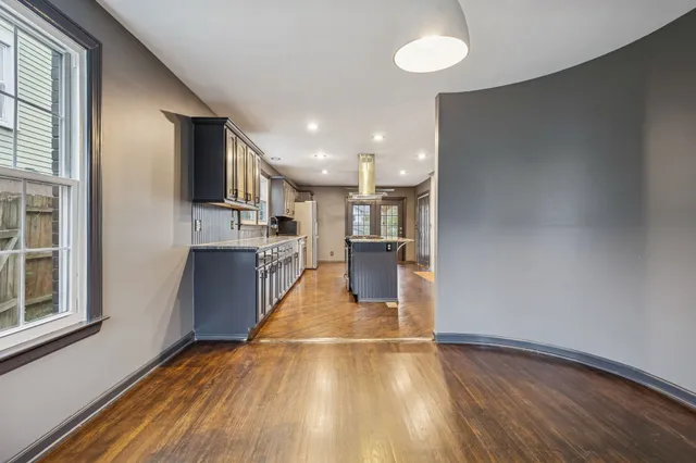 a view of kitchen with cabinets and wooden floor
