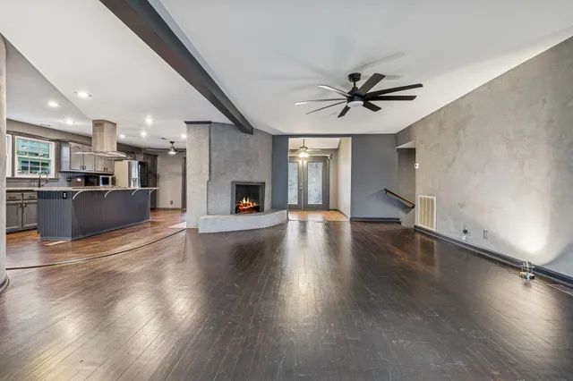 a view of a kitchen with a stove wooden cabinets and a fireplace
