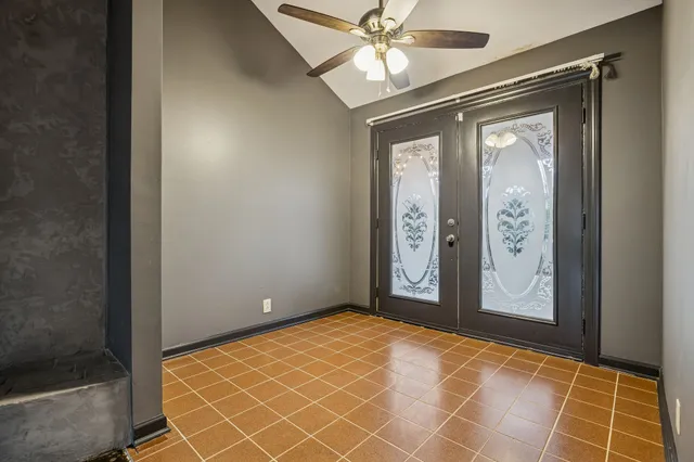 a view of a hallway with wooden floor and chandelier