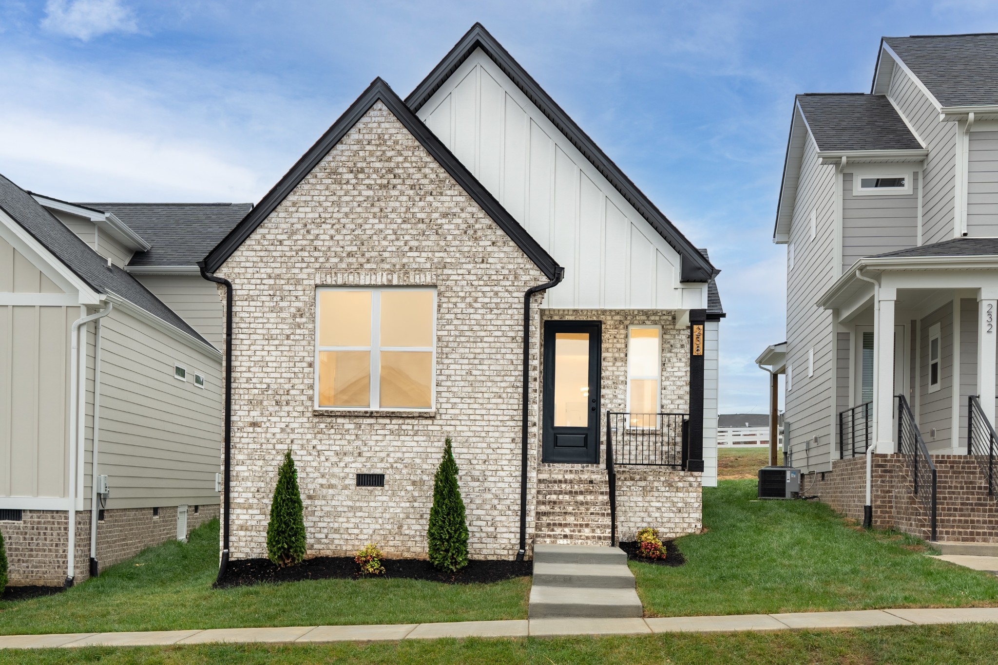 a view of a brick house with large windows