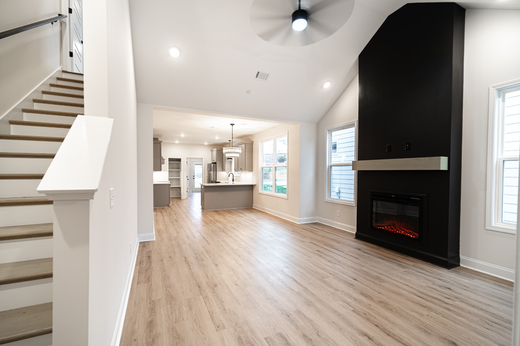 238 Franklin Street Pleasant View, TN 37146 - Photo 2 of 27 an empty room with wooden floor a fireplace and windows
