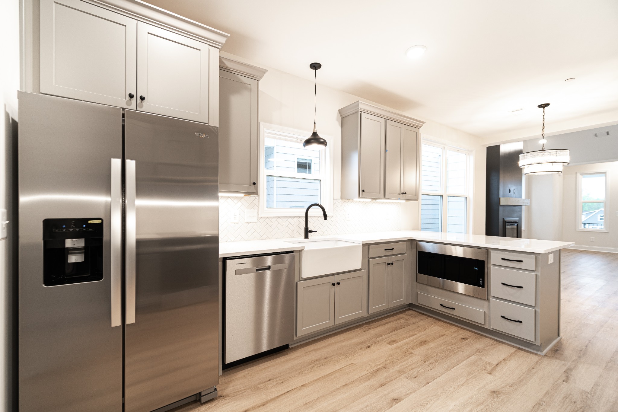 238 Franklin Street Pleasant View, TN 37146 - Photo 3 of 27 a kitchen with stainless steel appliances granite countertop a refrigerator a sink dishwasher and a stove with wooden floor