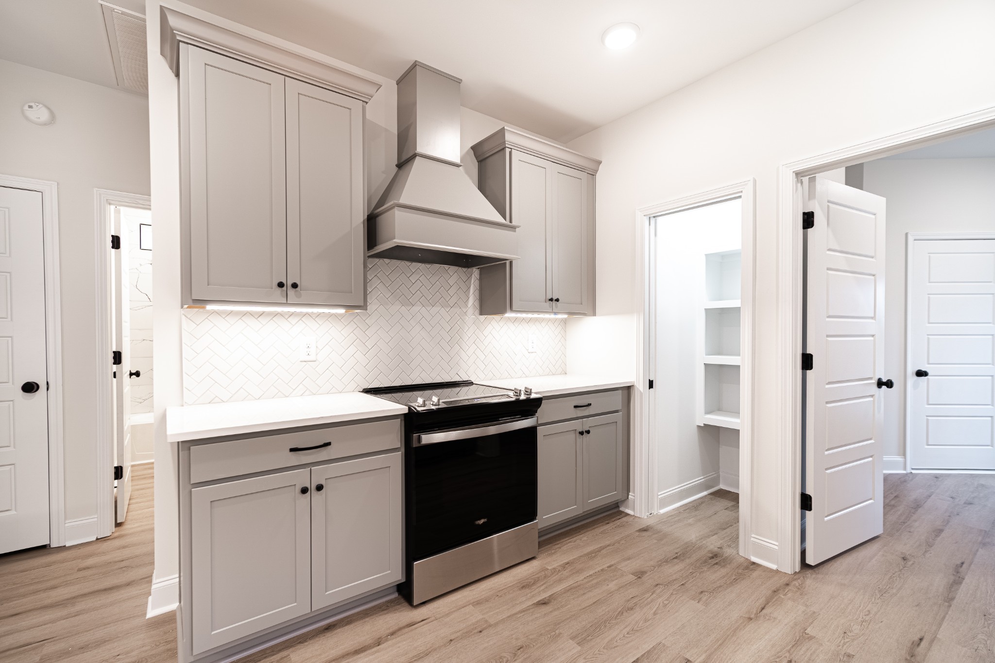 238 Franklin Street Pleasant View, TN 37146 - Photo 4 of 27 a kitchen with stainless steel appliances a sink cabinets and wooden floor