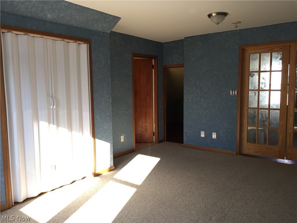 4687 Anderson Road Cleveland, OH 44121 - Photo 15 of 19 Master bedroom. Glass doors to stairs and office alcove. Center door to master bath. White door to closet.