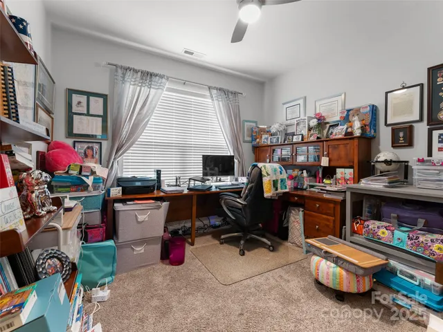 a room with furniture a rug toys and a window