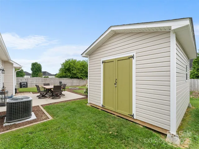 a view of a backyard with sitting area and slide