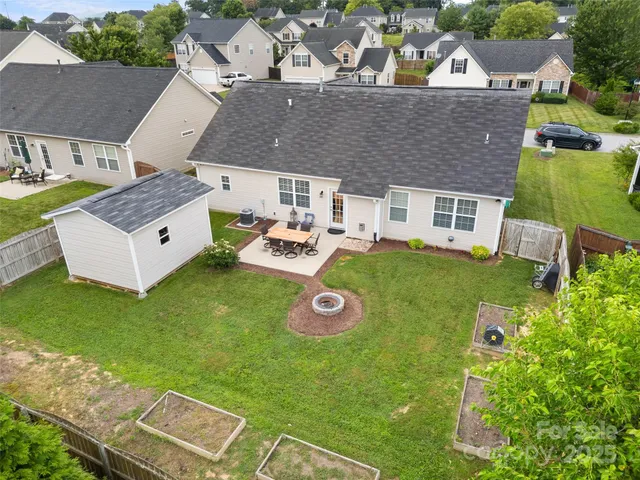an aerial view of a house with backyard outdoor space and swimming pool