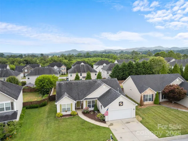 an aerial view of a house with a big yard