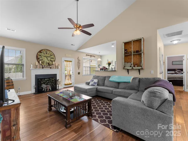 a living room with furniture a fireplace and a window