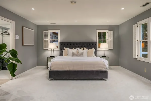 a bedroom with a bed plant and a window