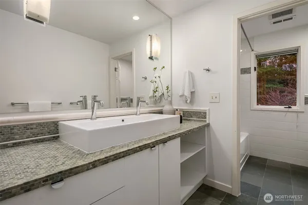 a bathroom with a double vanity sink mirror and double