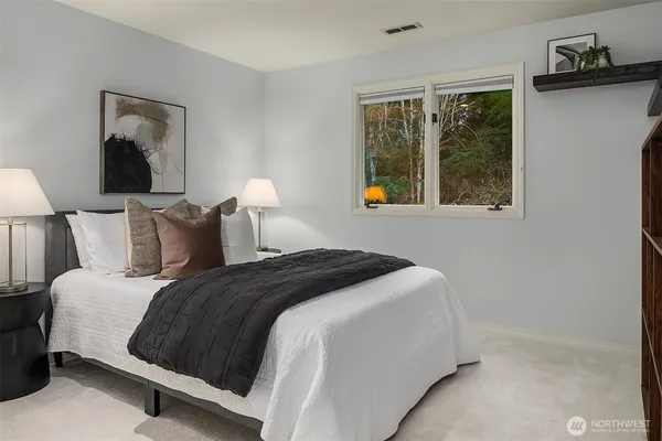 a bedroom with bed and window