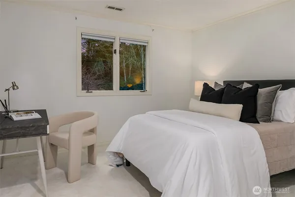 a bedroom with a bed and a window