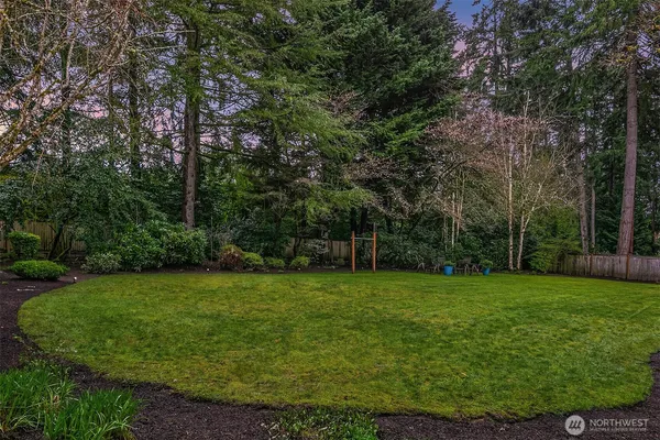 a view of a grassy field with trees in the background