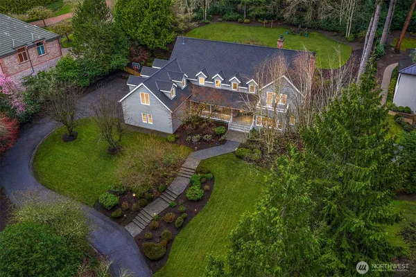 an aerial view of a house with a yard basket ball court and outdoor seating