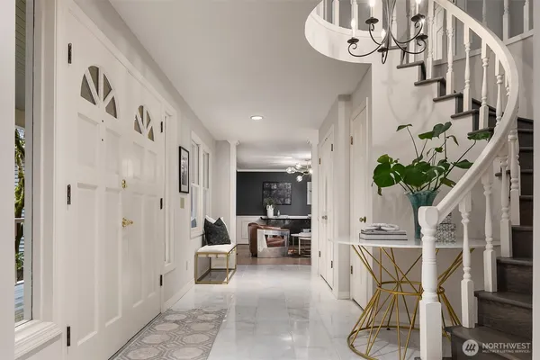 a view of a hallway with furniture and chandelier