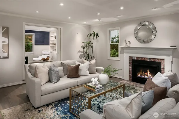a living room with furniture a window and a fireplace