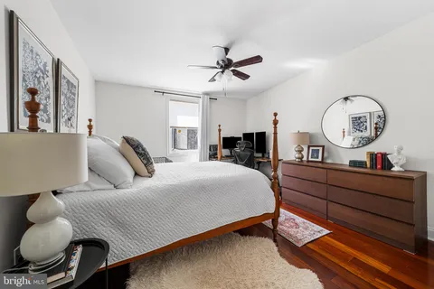 a bed room with a bed mirror and a chandelier