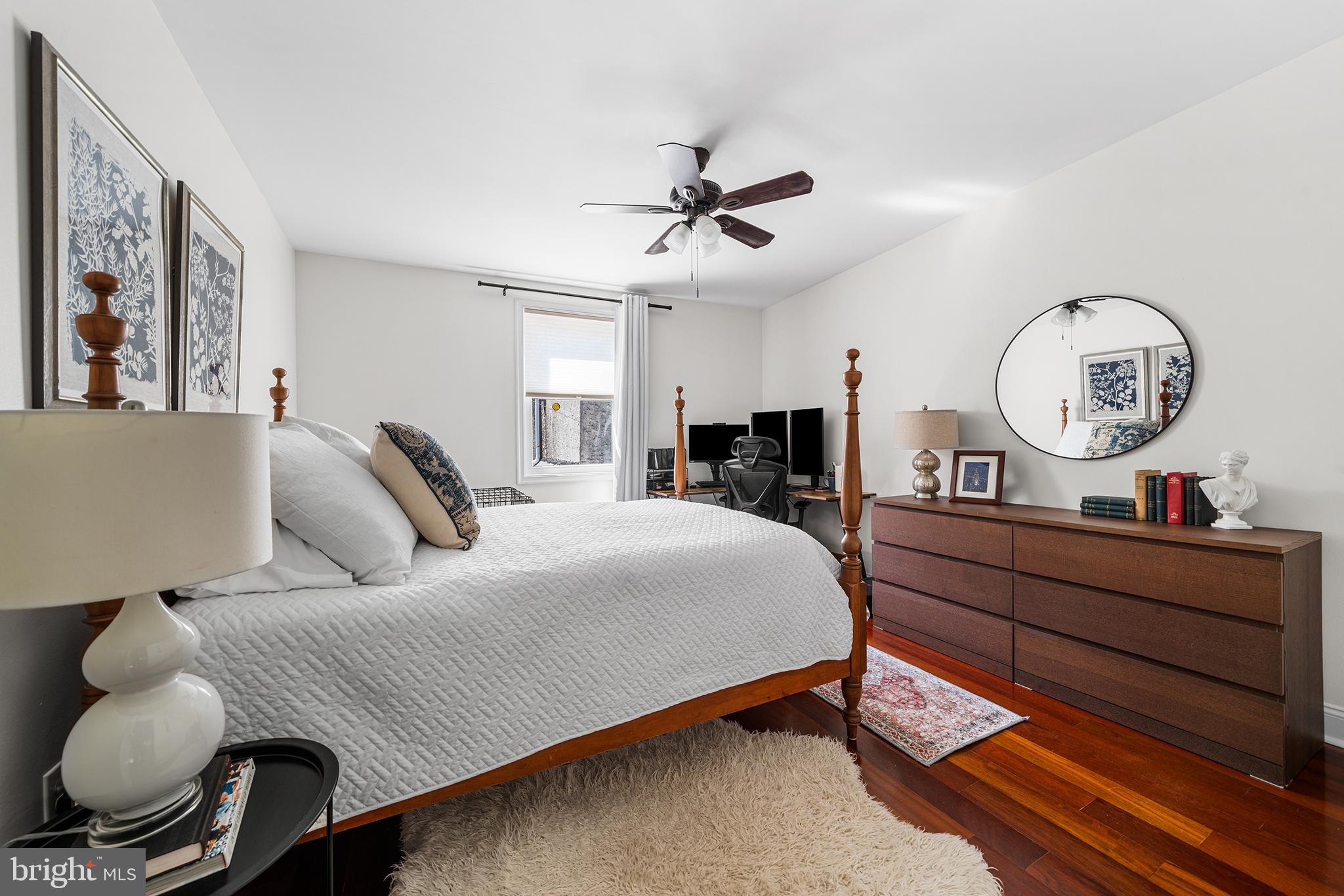 2520 Webster Street Philadelphia, PA 19146 - Photo 13 of 24 a bed room with a bed mirror and a chandelier