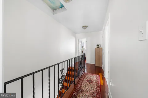a view of hallway with wooden floor