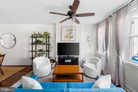 a living room with furniture a rug and a window