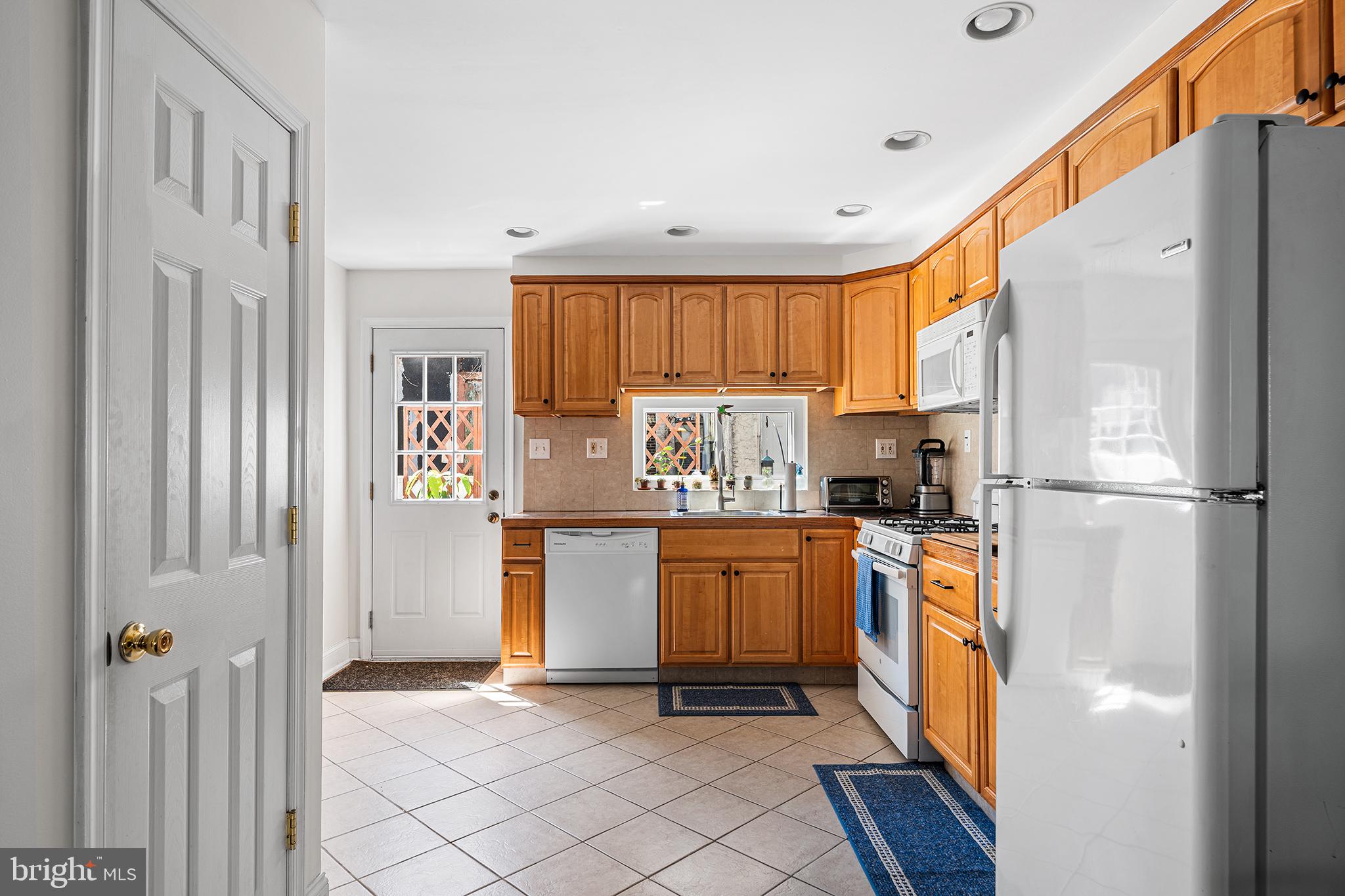 2520 Webster Street Philadelphia, PA 19146 - Photo 10 of 24 a kitchen with stainless steel appliances granite countertop a refrigerator and a stove top oven