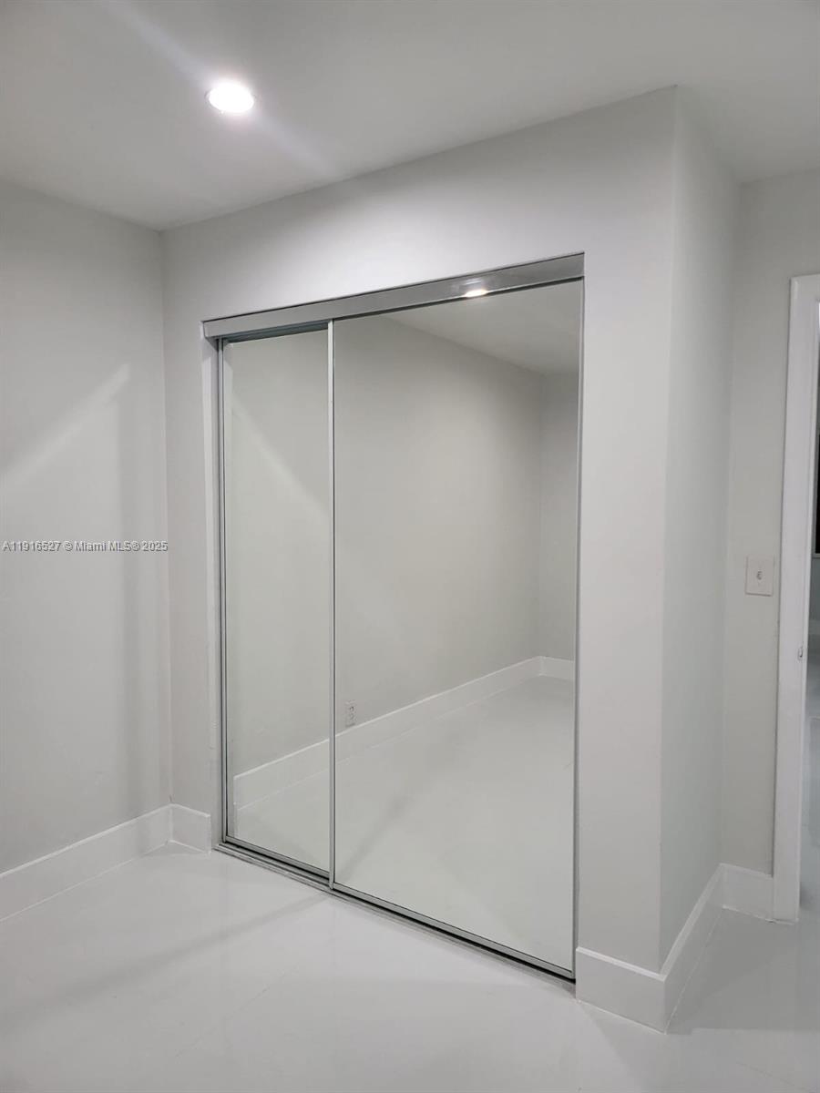 9375 Southwest 40th Terrace, Unit 203 Miami, FL 33165 - Photo 4 of 7 a bathroom with a glass shower door