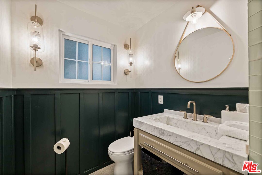 27643 West Shore Road, Unit 1 Lake Arrowhead, CA 92352 - Photo 24 of 31 a bathroom with a sink mirror and toilet