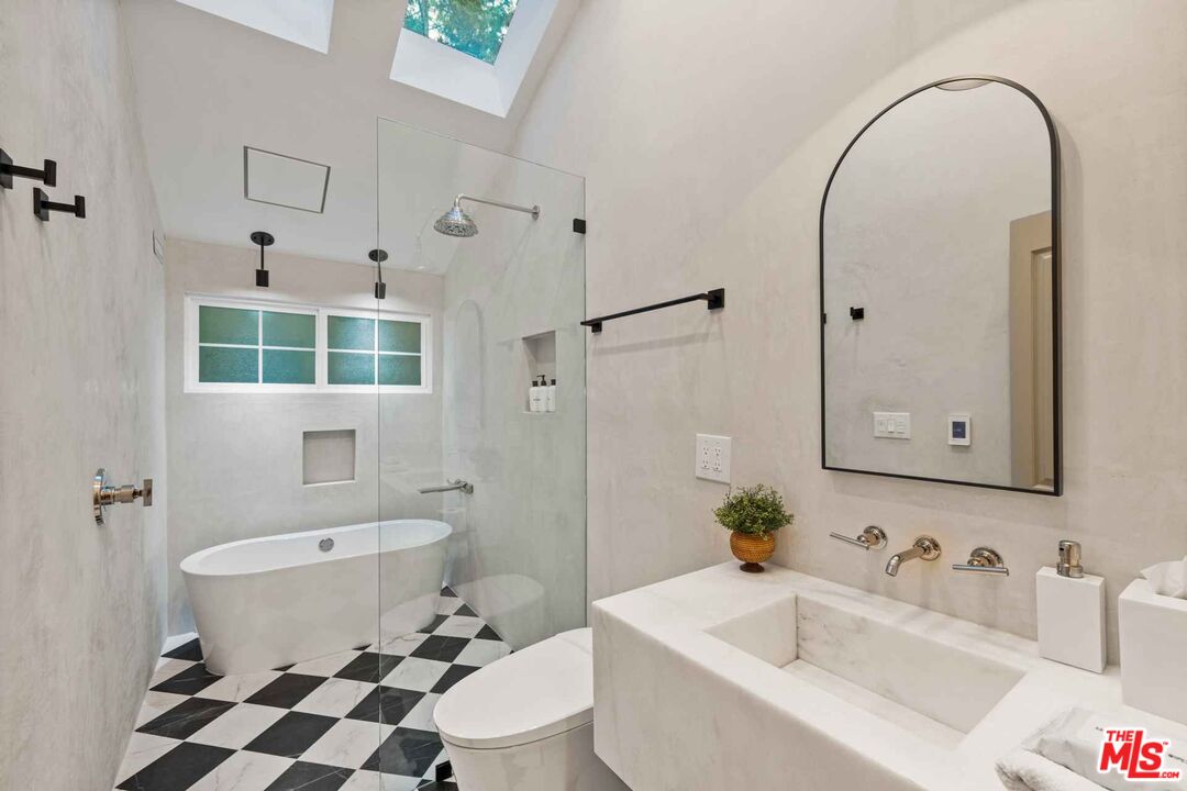 27643 West Shore Road, Unit 1 Lake Arrowhead, CA 92352 - Photo 28 of 31 a bathroom with a sink toilet a mirror and shower