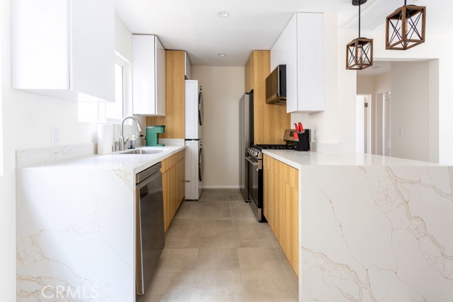 a kitchen with a sink stove and refrigerator
