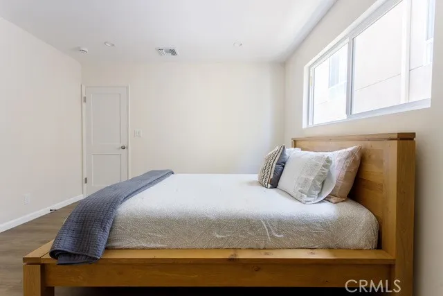 a bedroom with a bed and window