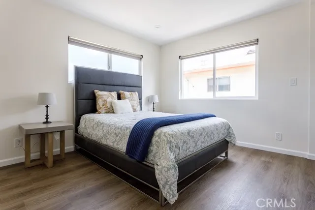 a large bed sitting in a bedroom next to a window