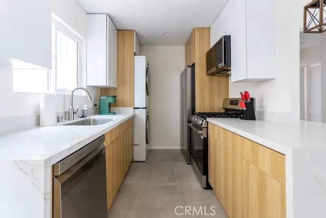 a kitchen with a sink and a stove top oven
