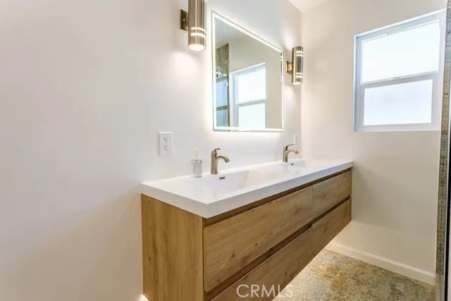 a bathroom with a sink and a mirror