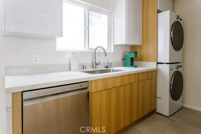 a utility room with sink dryer and washer