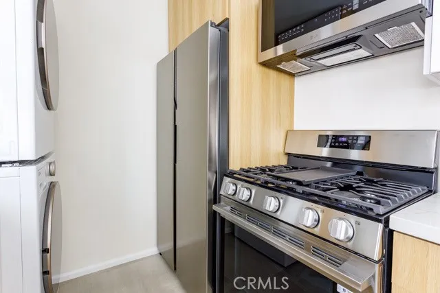 a stove top oven sitting inside of a kitchen