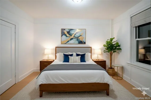 a bedroom with a bed and a potted plant