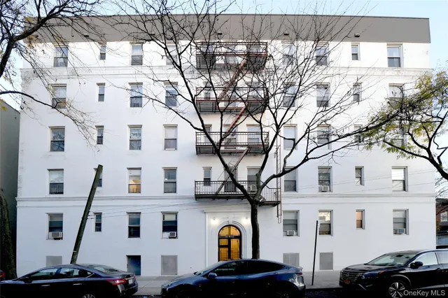 a front view of a building with parking space