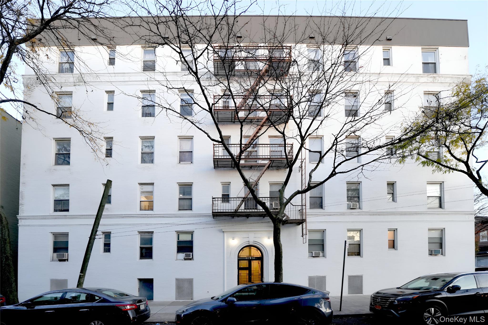 3775 64th Street, Unit 31 Queens, NY 11377 - Photo 17 of 18 a front view of a building with parking space