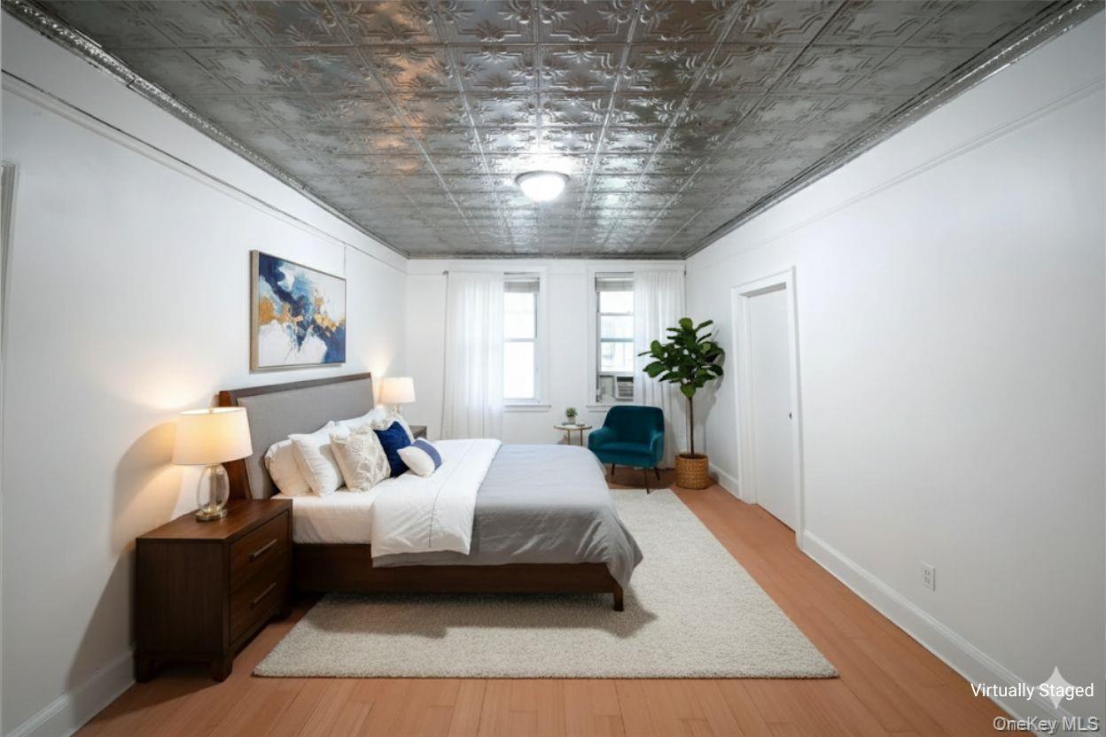 3775 64th Street, Unit 31 Queens, NY 11377 - Photo 5 of 18 a bedroom with a large bed and a couch